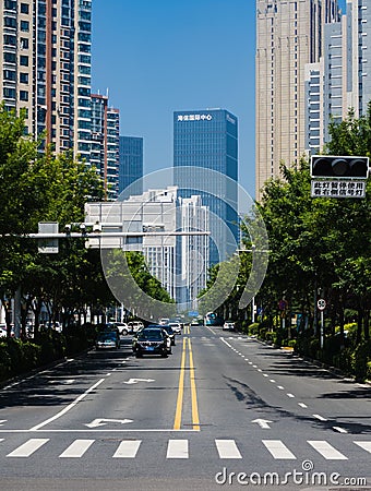 Vertical shot of a road with the background of tall buildings Editorial Stock Photo