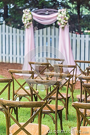Vertical shot of rows of wooden tables on the outdoor wedding ceremony Stock Photo