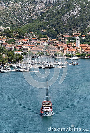 Vertical shot of ships and boats on a river surrounded by the Old Town of Skradin, Croatia Editorial Stock Photo
