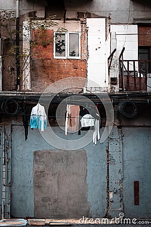 Vertical shot of a simple courtyard with clothes hang from a power cords Editorial Stock Photo
