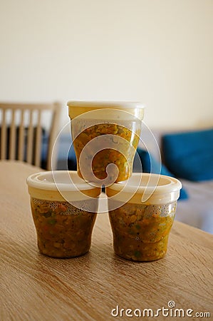 Vertical shot of small containers filled with baby food Stock Photo