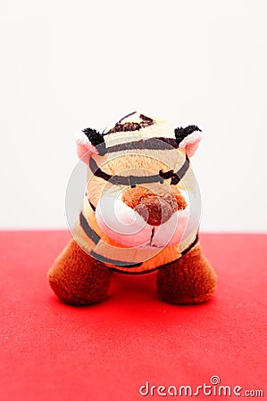 Vertical shot of a soft tiger toy on a pink background Stock Photo