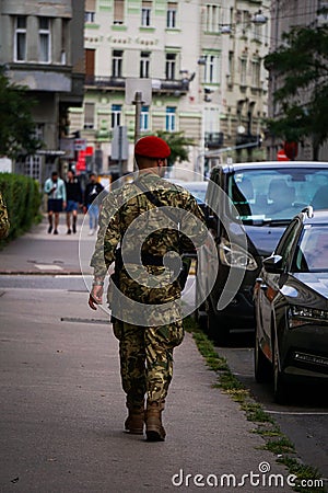 Vertical shot of a soldier walking on the street Editorial Stock Photo