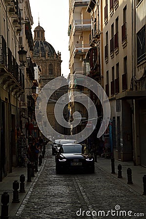 Vertical shot of a street in Granada with the Iglesia de los Santos Justo y Pastor basilisk Editorial Stock Photo
