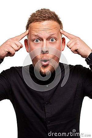 Vertical shot of stupefied stunned shocked young male keeps mouth widely opened, being surprised and very emotional Stock Photo