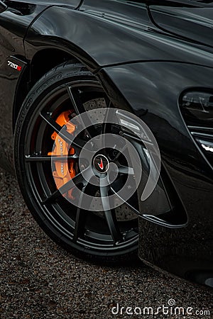 Vertical shot of the stylish rims of a luxurious black McLaren automobile Editorial Stock Photo