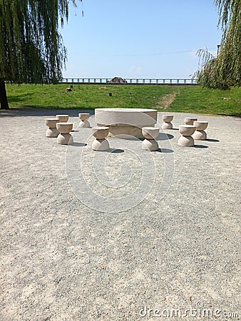 Vertical shot of the Table of Silence under blue sky in a park in Romania Stock Photo