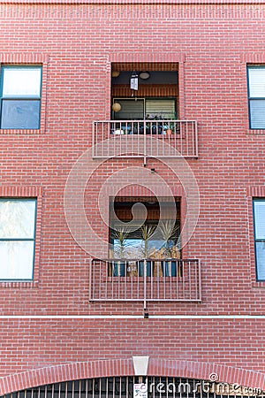 Vertical shot of a tall brick building with balcones Editorial Stock Photo