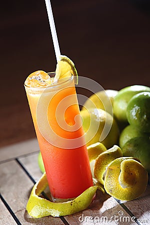 Vertical shot of Tequila Sunrise cocktail in tall glass with straw Stock Photo