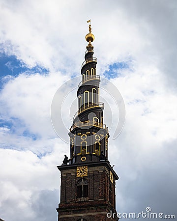 Vertical shot of the tower of Church of Savoir over a background of a cloudy sky Stock Photo