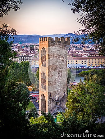 Vertical shot of The Tower of San Niccolo surrounded by buildings and trees in Florence, Italy Stock Photo