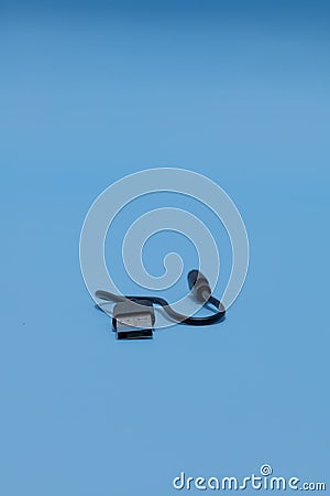 Vertical shot of type A to Micro USB cable on a blue background Stock Photo