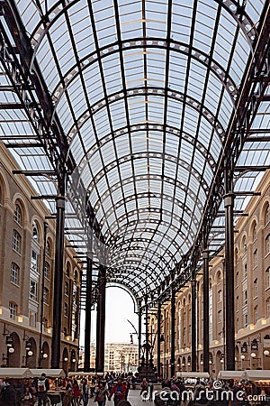 Vertical shot of unidentified people walking and shopping in Hay's Galleria in London Editorial Stock Photo