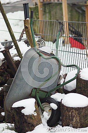 Vertical shot of an upside-down wheelbarrow during winter Stock Photo