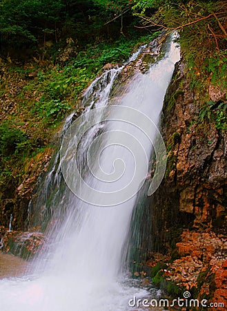 Vertical shot of the Urlatoarea waterfall in Romania Stock Photo