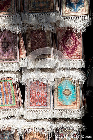 Vertical shot of various small prayer rugs at a souvenir shop Stock Photo