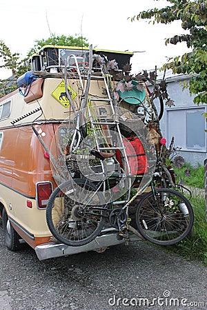 Vertical shot of a vintage van with a bicycle and tools fixed behind it Editorial Stock Photo