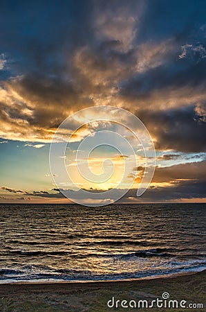 Vertical shot of waves crashing the shore at sunset, cool for abckground Stock Photo