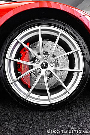 Vertical shot of the wheel of a Ferrari 812 Superfast with a carbon ceramic brake rotor Editorial Stock Photo