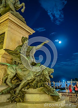 Vertical shot of a winged lion monument of Victor Emmanuel II at night in Venice, Italy Stock Photo