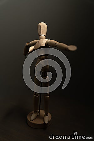 Vertical shot of a wooden figure of a human Stock Photo