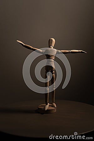 Vertical shot of a wooden figure of a human Stock Photo