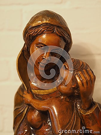 Vertical shot of a wooden Mother Marry sculpting statue Stock Photo
