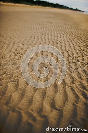 Vertical shot of wrinkles on the sand of the beach Stock Photo