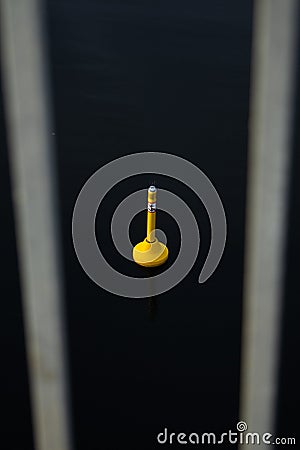 Vertical shot of a yellow buoy on the water Stock Photo