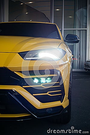 Vertical shot of the yellow Lamborghini Urus Front with headlights on Editorial Stock Photo