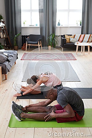 Man And Woman Doing Stretching Exercise Stock Photo