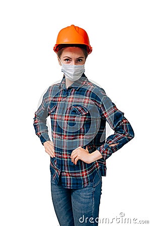 Vertical shot of young girl builder in medical mask looks menacingly with contempt at the camera Stock Photo