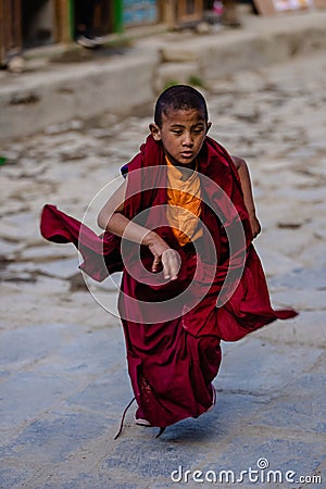 Vertical shot of a young Tibetan Buddhist Monk at the Tiji Festival in Lo Manthang Upper Mustang Editorial Stock Photo