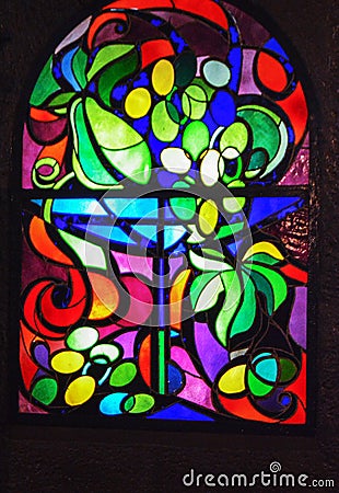 Vertical stained glass window with abstract background of multicolored glass with plant and fruit ornaments Editorial Stock Photo