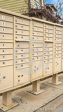 Vertical tall frame Residential mailboxes with numbered compartments on the side of a road Editorial Stock Photo