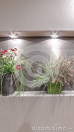 Vertical Three flower arrangements in a wall alcove Stock Photo