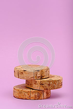 Vertical three wooden sawn podium on pink background, showcase concept Stock Photo