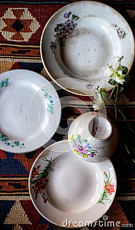 Vertical top-view of a composition of white vintage ceramic plates and a teapot Stock Photo