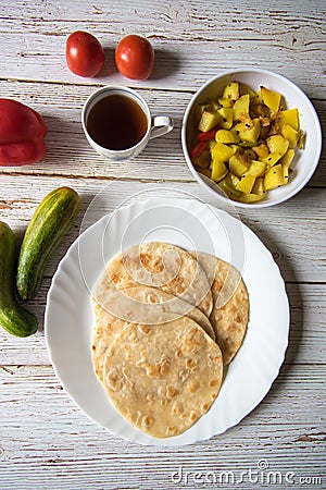 Vertical top view of popular Indian breakfast puri and sabzi Stock Photo