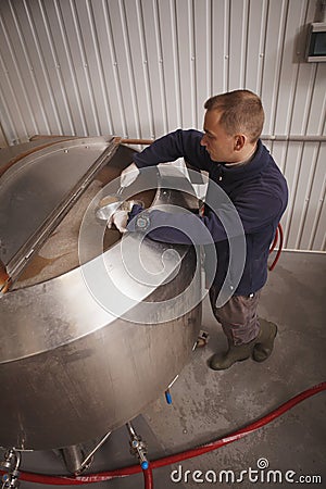 Man brewing beer at his brewery Stock Photo