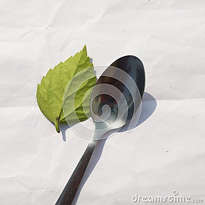 Vertical top view shot of table kitchen silver spon isolated. Silver spon is on a white linens background with negative space. Stock Photo