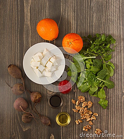 Vertical top view of a wooden table of ingredients for beet salad with oranges and feta cheese Stock Photo