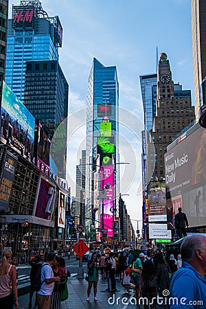 Vertical twilight view of crowded Times Square Broadway Avenue full of tourists Editorial Stock Photo