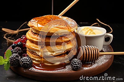 Vertical view captures delectable breakfast croissant, stacked pancakes, cookies on dark table Stock Photo