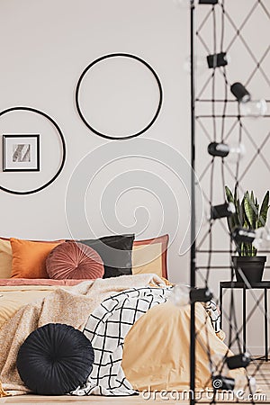 Vertical view of classy bedroom interior with colorful bedding and round pillows Stock Photo