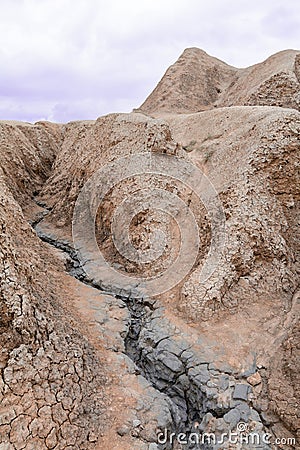 Vertical view with dramatic cracked slope. Dry land in natural p Stock Photo