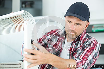 Vertical view fixing radiator at home Stock Photo