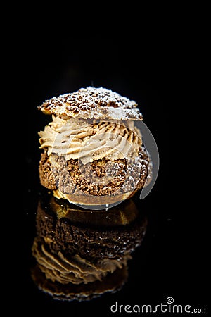 vertical view on french profiterole on black background Stock Photo