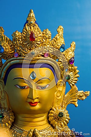 Gold covered statue of buddhist deity of compassion Chenrezig. Stock Photo