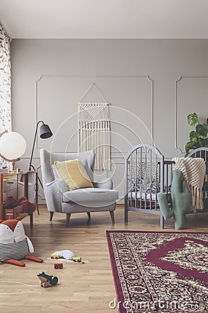 Vertical view of mid century baby room with patterned bedding Stock Photo